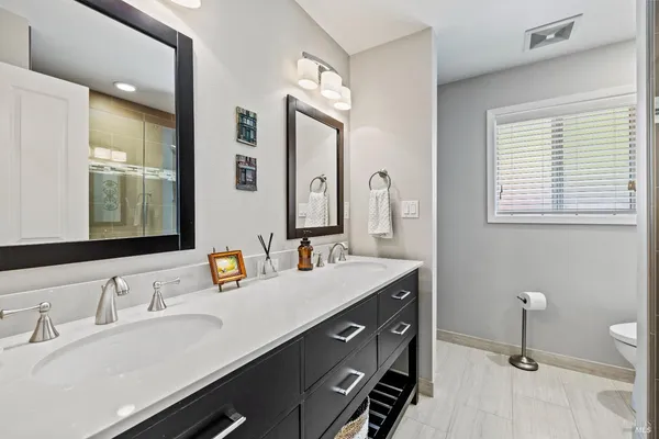 a living room with furniture and a dining table with wooden floor