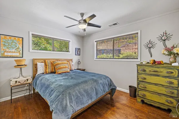 a bed room with a bed and a tv on the dresser