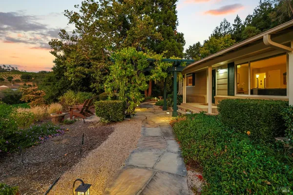 a living room with furniture a fireplace and a table