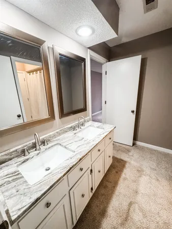 a bathroom with double sink and a mirror