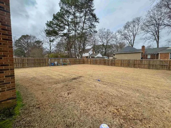 a swimming pool with trees in the background