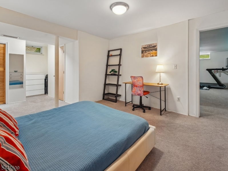 610 River Road Chatham, NJ 07928 - Photo 28 of 42 a bed room with a bed and a chair