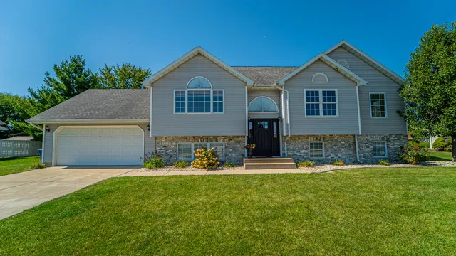 a front view of a house with a yard and garage