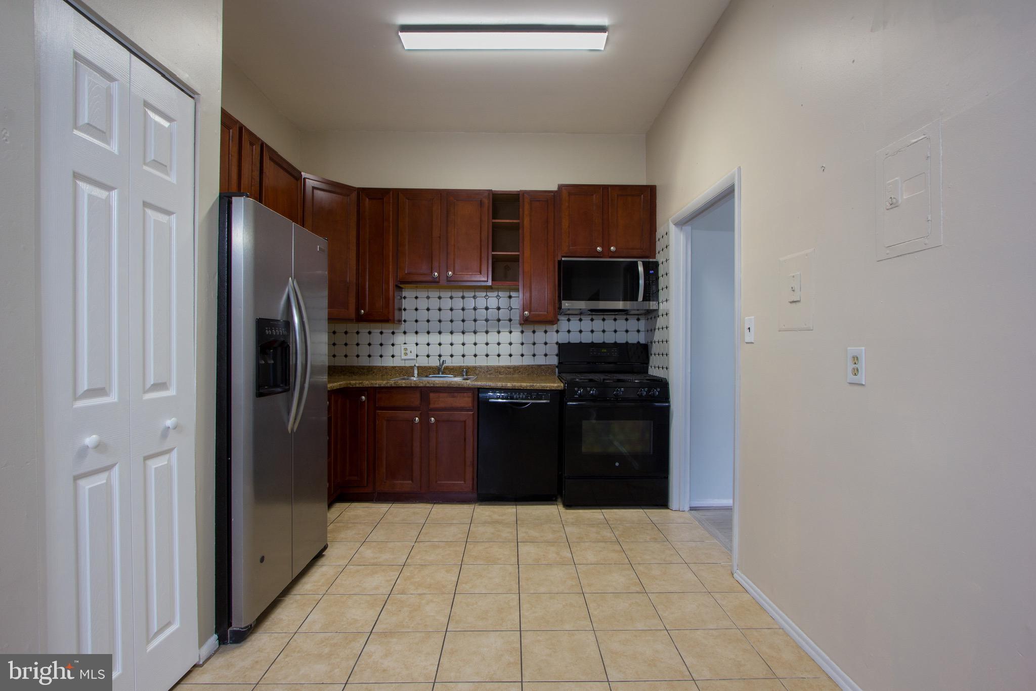 14426 Parkvale Road, Unit 5 Rockville, MD 20853 - Photo 13 of 26 a kitchen with stainless steel appliances a refrigerator and stove