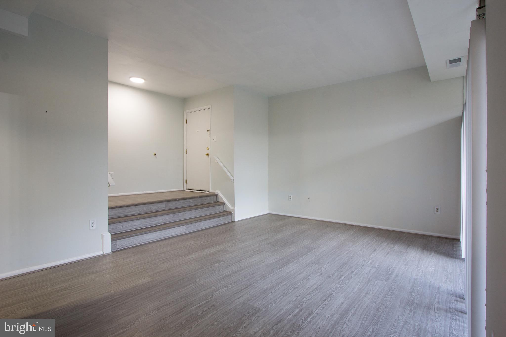 14426 Parkvale Road, Unit 5 Rockville, MD 20853 - Photo 15 of 26 a view of an empty room with wooden floor and a window