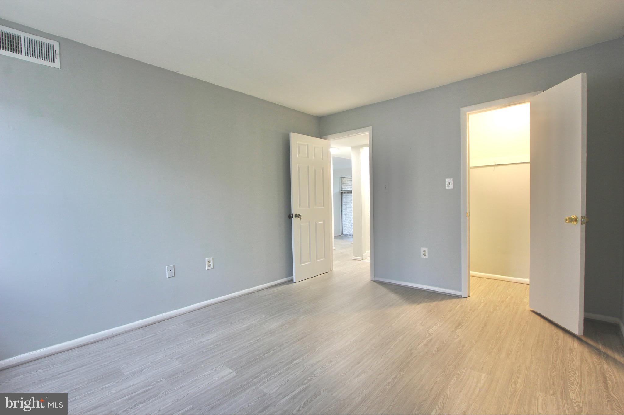 14426 Parkvale Road, Unit 5 Rockville, MD 20853 - Photo 19 of 26 a view of an empty room with wooden floor and a window