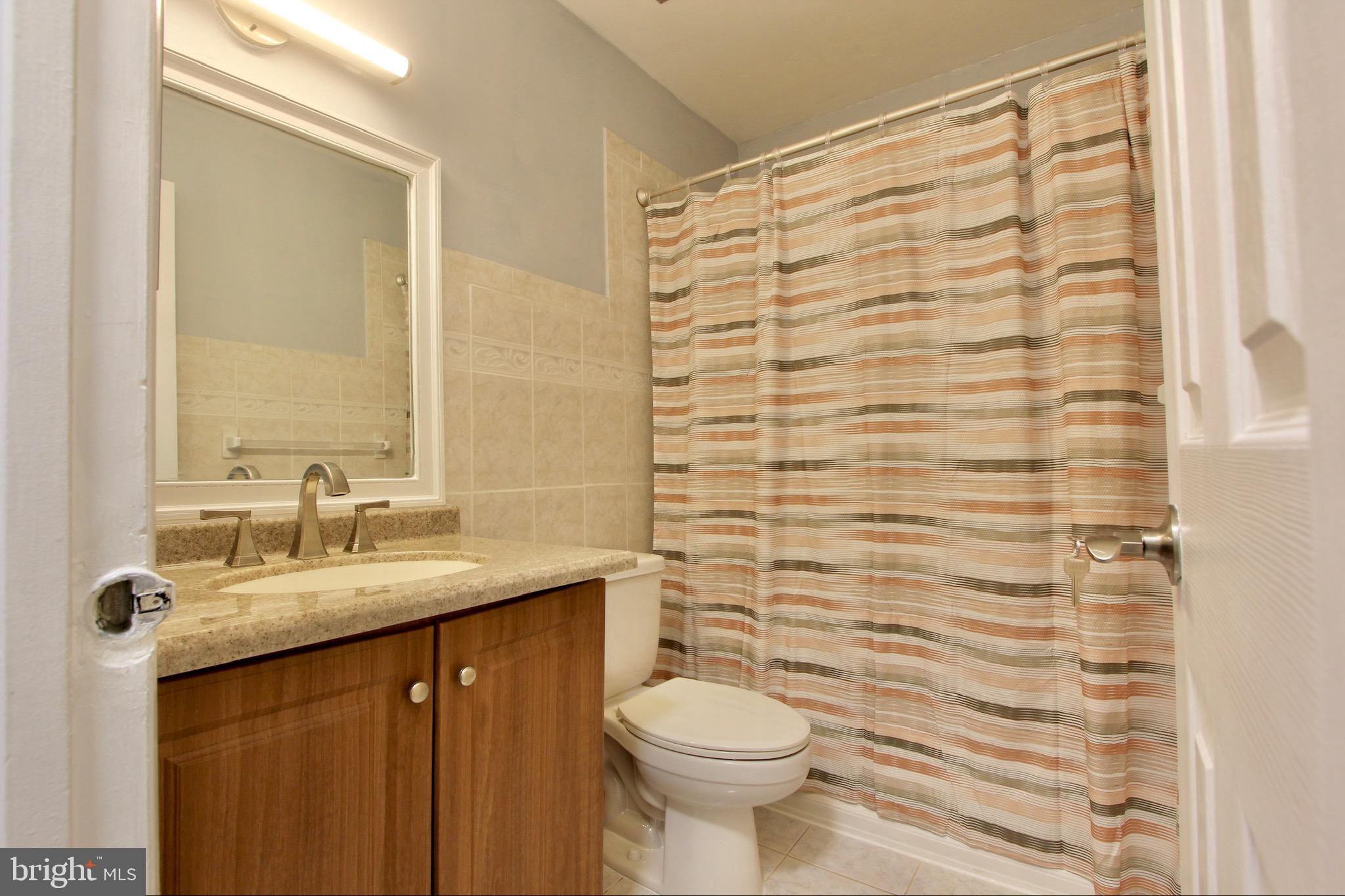 14426 Parkvale Road, Unit 5 Rockville, MD 20853 - Photo 20 of 26 a bathroom with a sink and a mirror