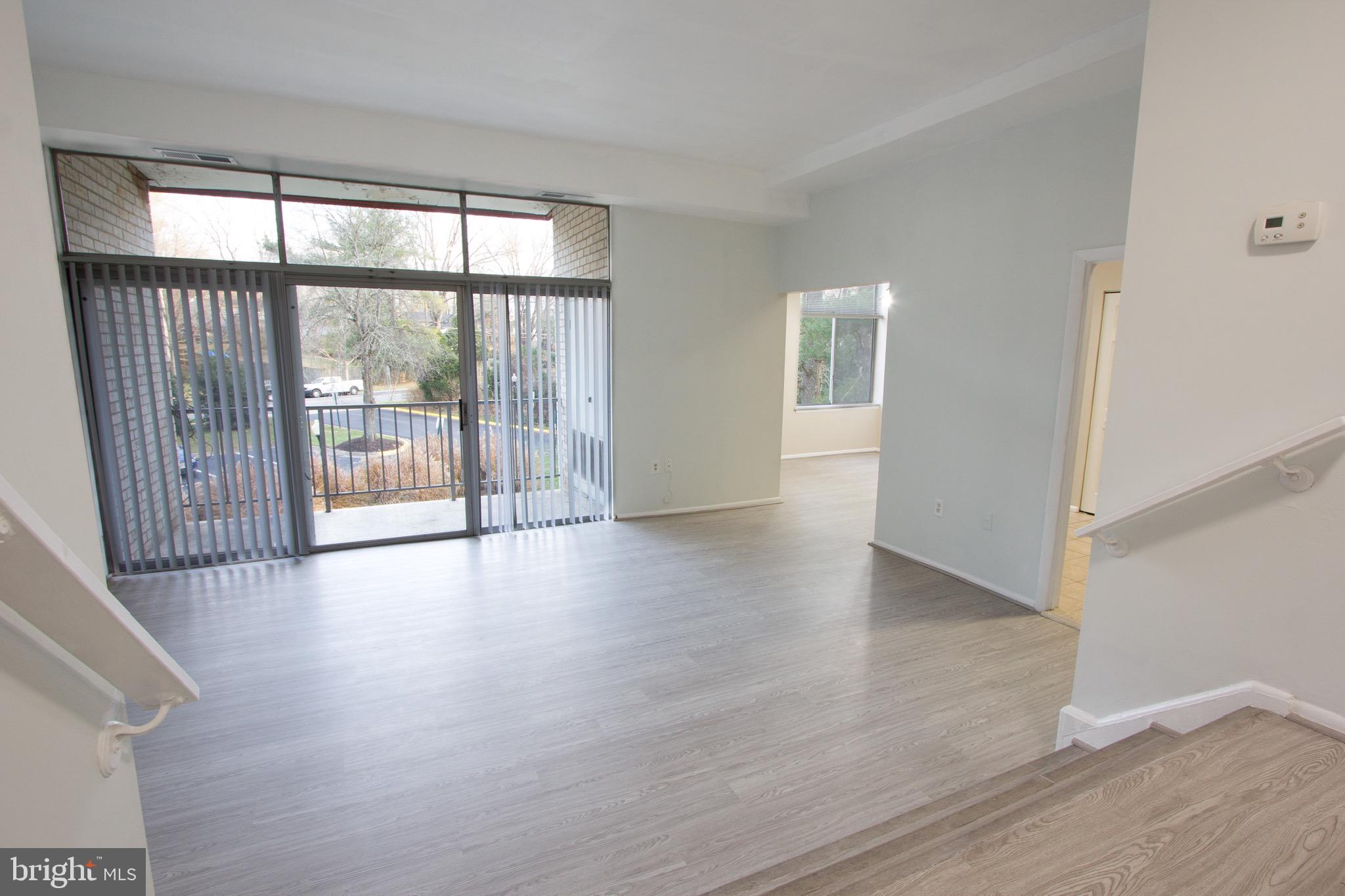 14426 Parkvale Road, Unit 5 Rockville, MD 20853 - Photo 4 of 26 an empty room with wooden floor and windows