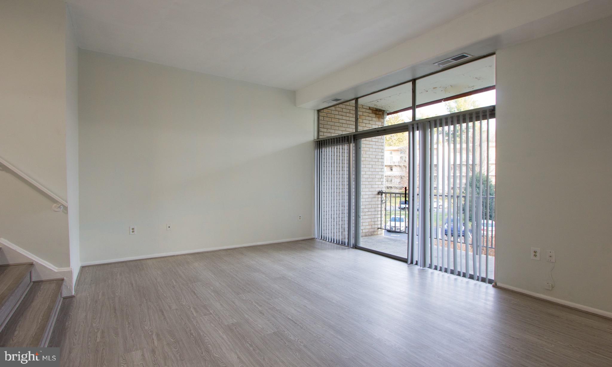 14426 Parkvale Road, Unit 5 Rockville, MD 20853 - Photo 6 of 26 wooden floor in an empty room with a window