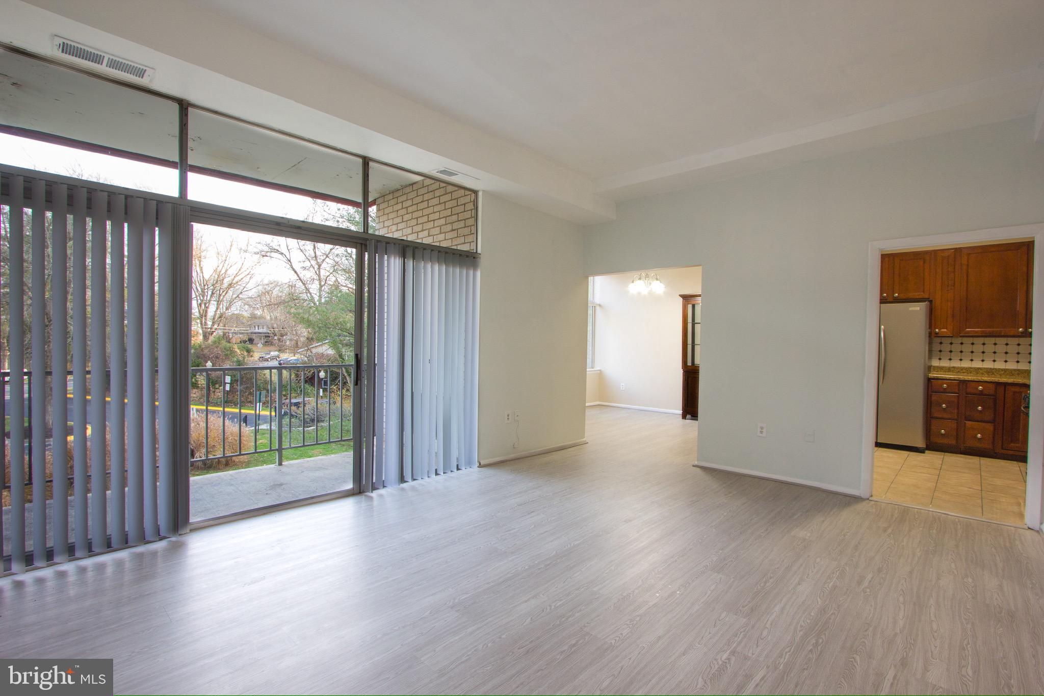 14426 Parkvale Road, Unit 5 Rockville, MD 20853 - Photo 7 of 26 a view of a room with wooden floor and a window