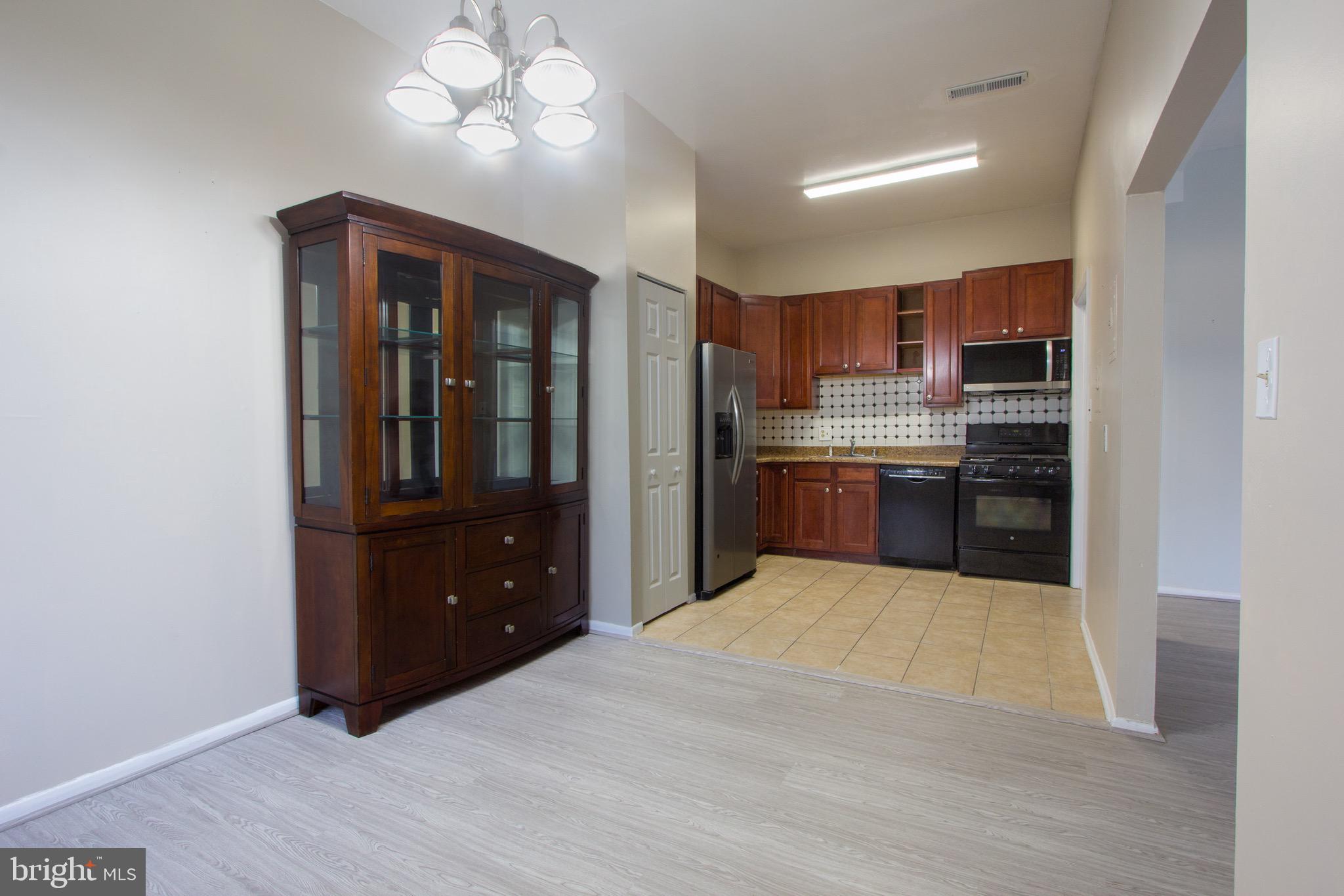 14426 Parkvale Road, Unit 5 Rockville, MD 20853 - Photo 10 of 26 a kitchen with stainless steel appliances granite countertop a refrigerator and a sink