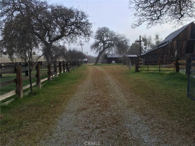 a bathroom with a granite countertop toilet sink and mirror