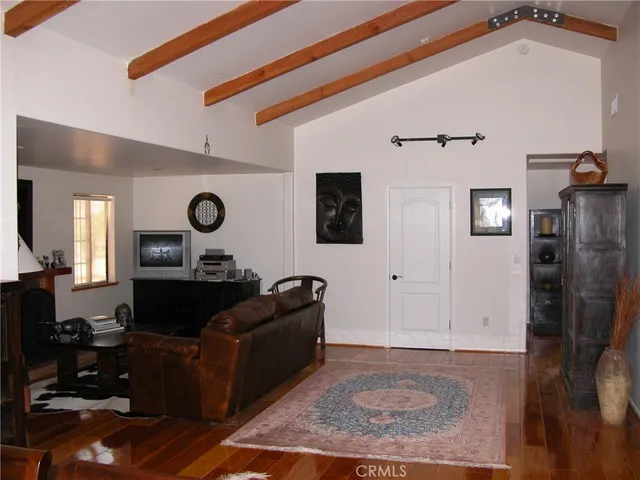 a living room with furniture and a mirror
