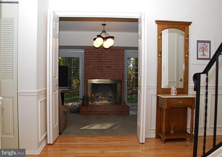 11313 Handlebar Road Reston, VA 20191 - Photo 10 of 29 Foyer Opens to Family Room Fireplace