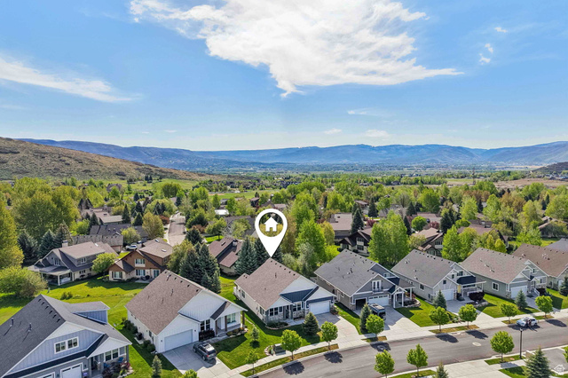 1238 Canyon View Road Midway, UT 84049 - Photo 33 of 36 Aerial perspective showcasing a residential street with homes featuring pitched roofs and attached garages