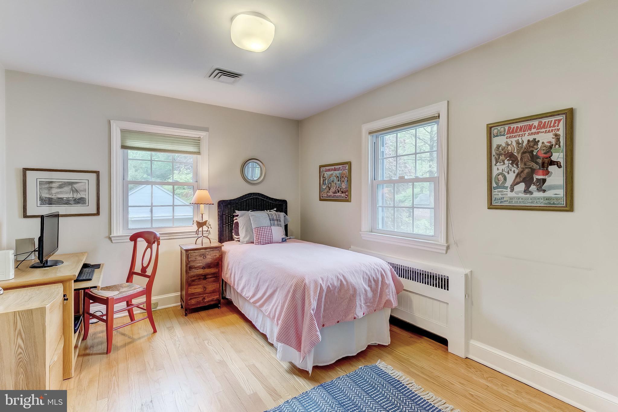 5704 Kenmore Road Baltimore, MD 21210 - Photo 19 of 30 a bedroom with a bed and wooden floor