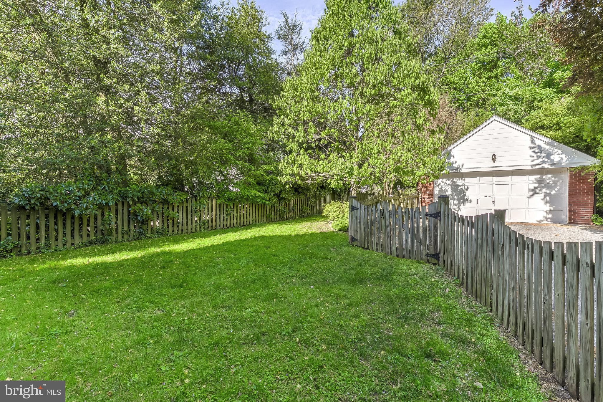 5704 Kenmore Road Baltimore, MD 21210 - Photo 27 of 30 a front view of a house with yard and trees
