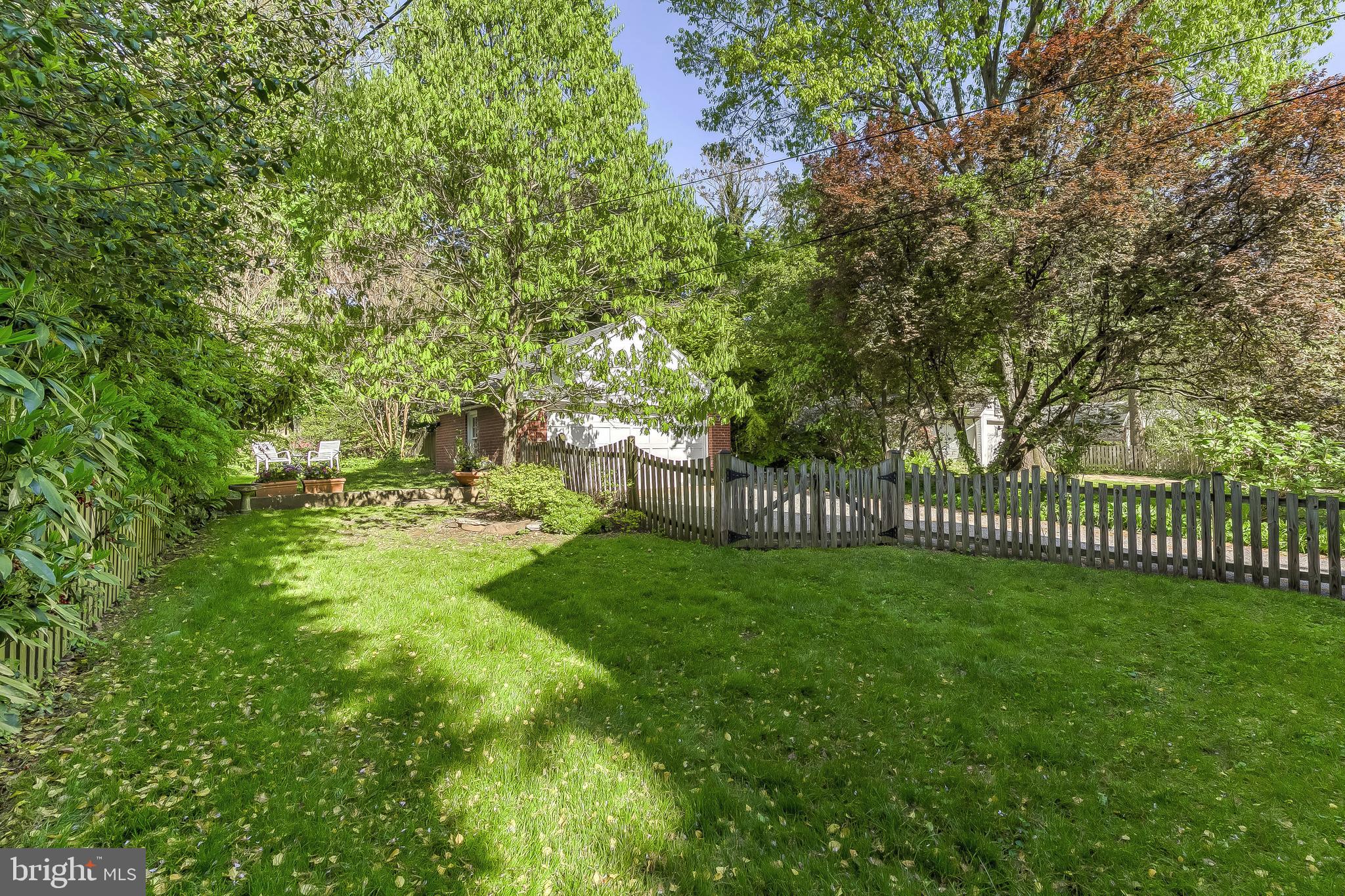 5704 Kenmore Road Baltimore, MD 21210 - Photo 28 of 30 a view of a yard with large trees and a small pool