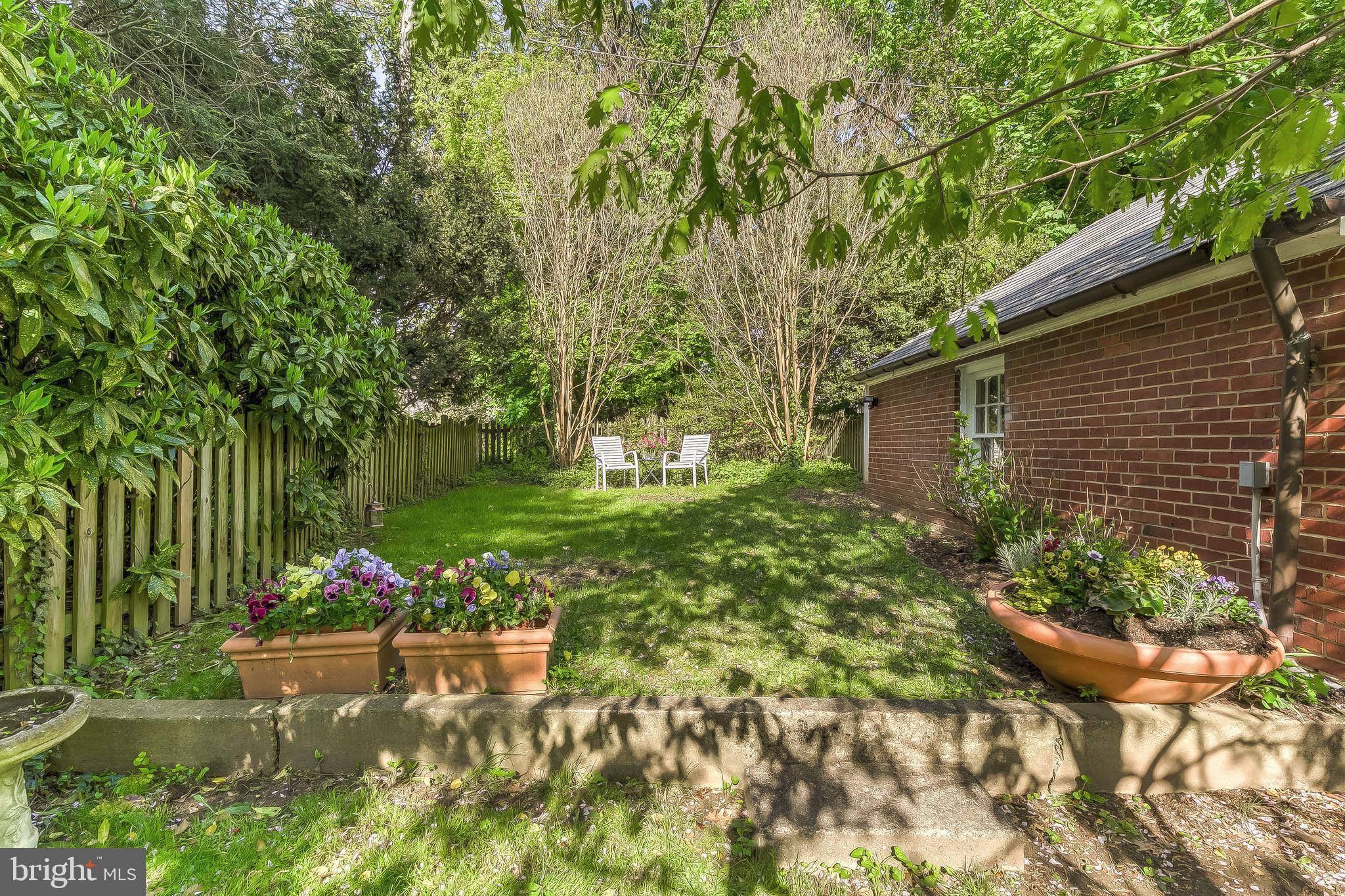 5704 Kenmore Road Baltimore, MD 21210 - Photo 30 of 30 a backyard of a house with lots of green space and fountain