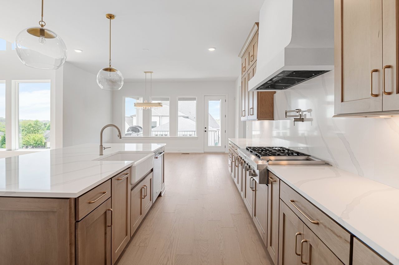 6065 Lookaway Circle Franklin, TN 37067 - Photo 15 of 39 a kitchen with granite countertop a sink stove and cabinets