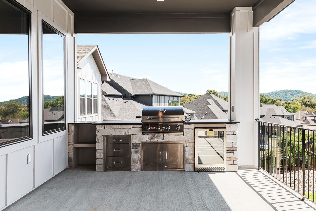 6065 Lookaway Circle Franklin, TN 37067 - Photo 38 of 39 a kitchen with stainless steel appliances a stove and wooden floor