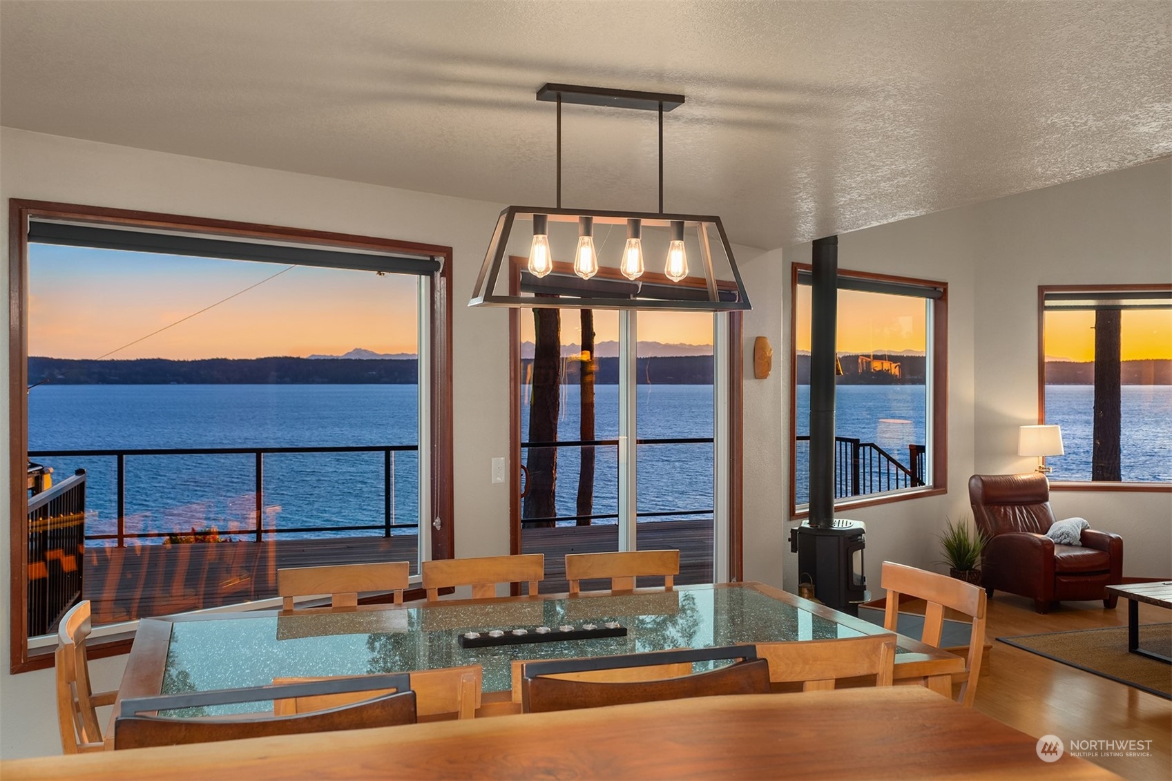 3480 Timothy Way Camano Island, WA 98282 - Photo 10 of 39 a room with lots of windows and wooden floor