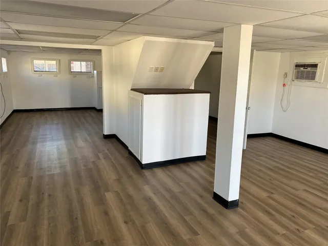 a view of a hallway with wooden floor and stairs