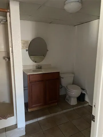 a bathroom with a toilet and a mirror