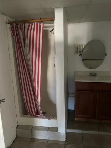 a bathroom with a mirror and a shower