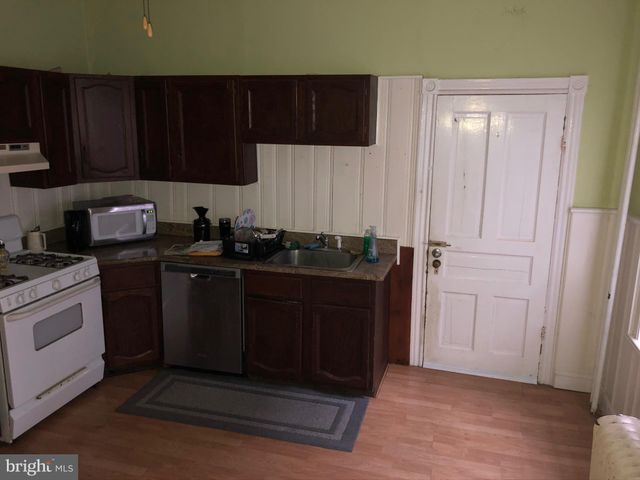 a kitchen with a refrigerator and a stove