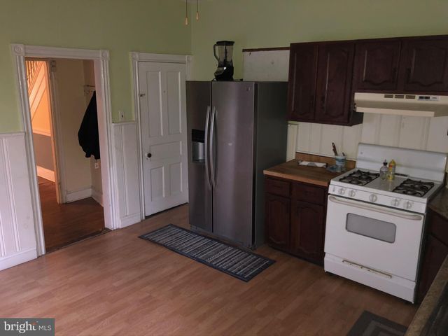 a view of an empty room and wooden floor