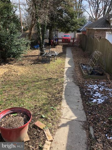 a view of a chairs and table in backyard