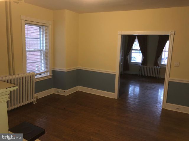 a view of a room with wooden floor windows and cabinet