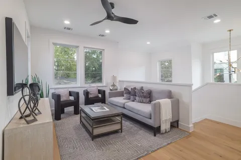 a living room with furniture lamp and potted plant