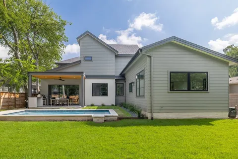 a view of house with backyard and a backyard