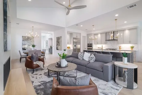 a living room with furniture and kitchen view