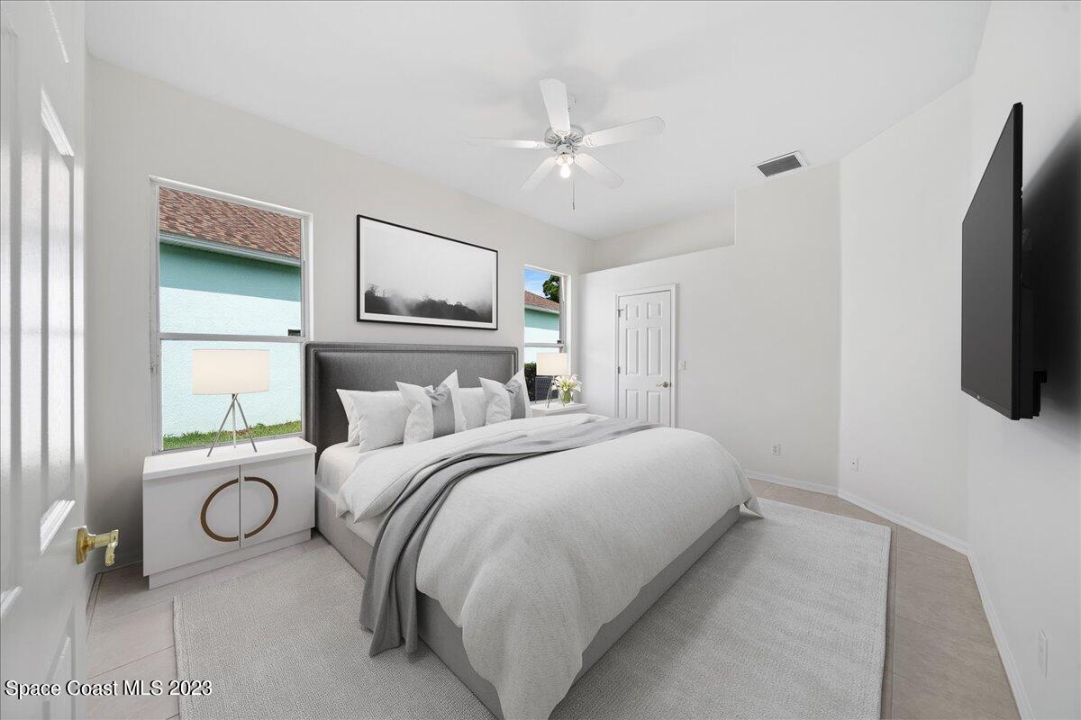 853 Villa Drive Melbourne, FL 32940 - Photo 16 of 28 a bedroom with a bed and a flat screen tv