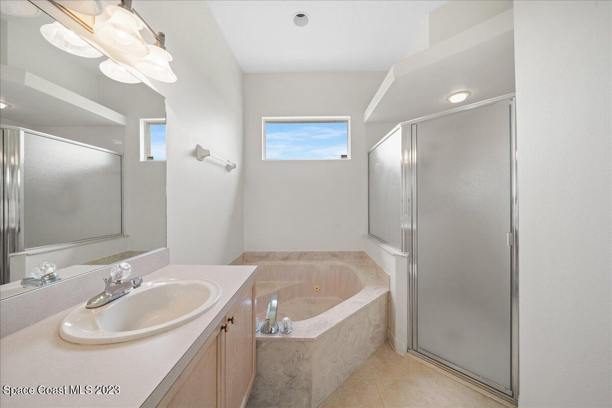 853 Villa Drive Melbourne, FL 32940 - Photo 20 of 28 a bathroom with a bathtub and a sink