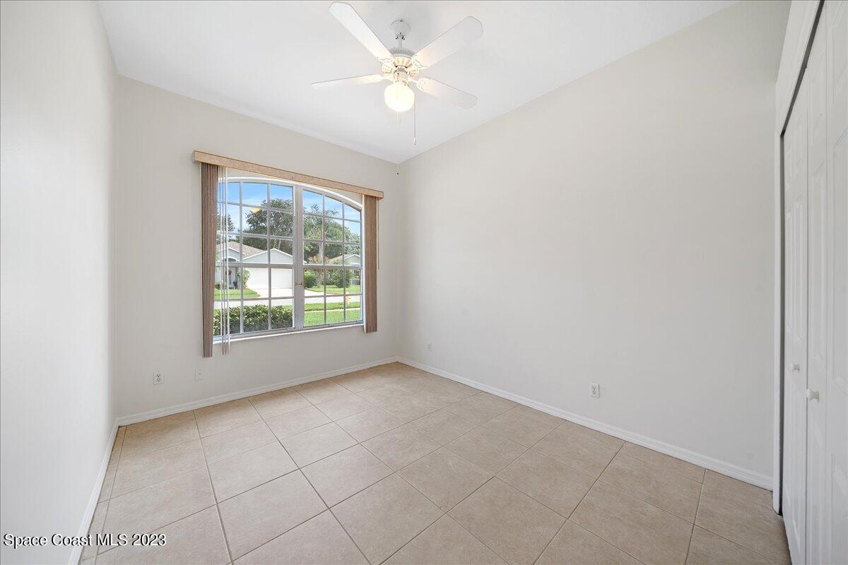 853 Villa Drive Melbourne, FL 32940 - Photo 21 of 28 an empty room with windows and fan