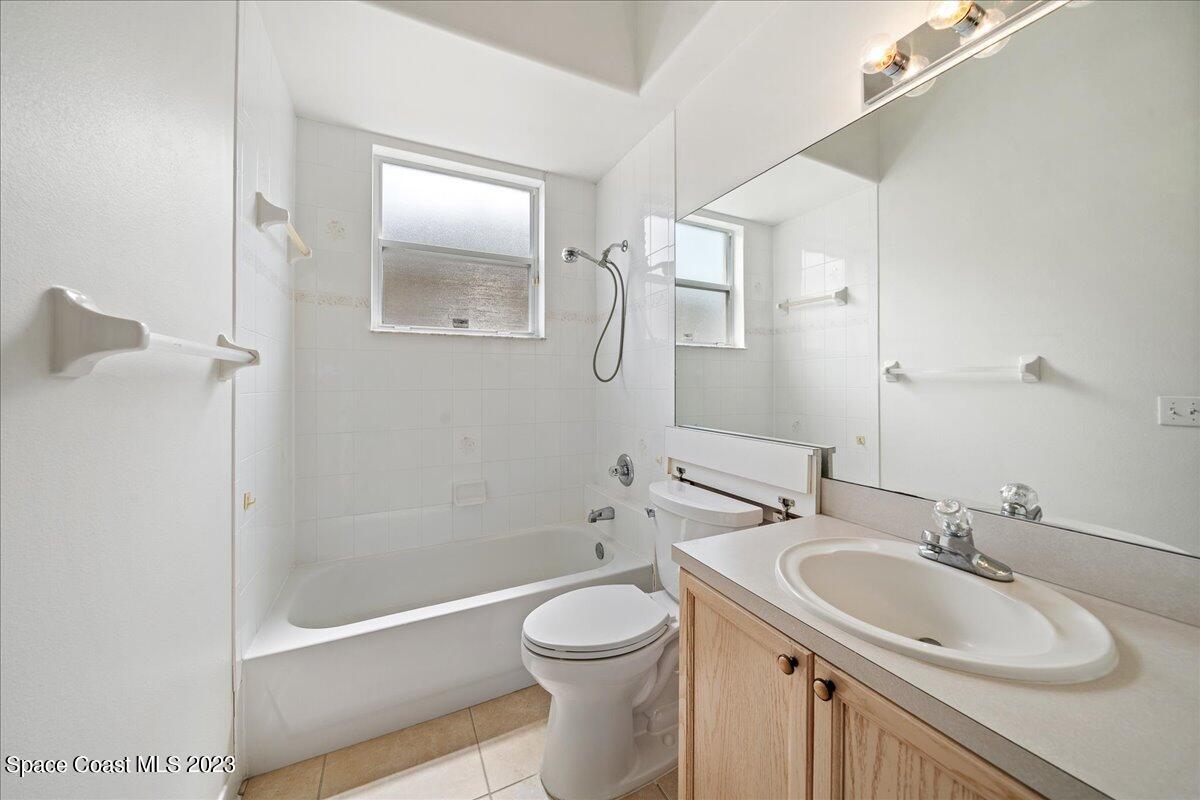 853 Villa Drive Melbourne, FL 32940 - Photo 22 of 28 a bathroom with a sink a toilet and shower