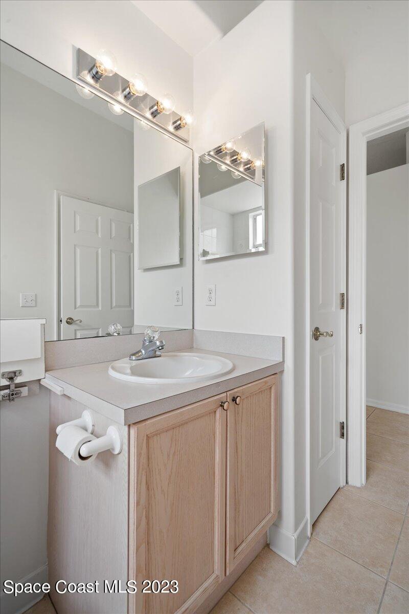 853 Villa Drive Melbourne, FL 32940 - Photo 23 of 28 a bathroom with a sink and a mirror