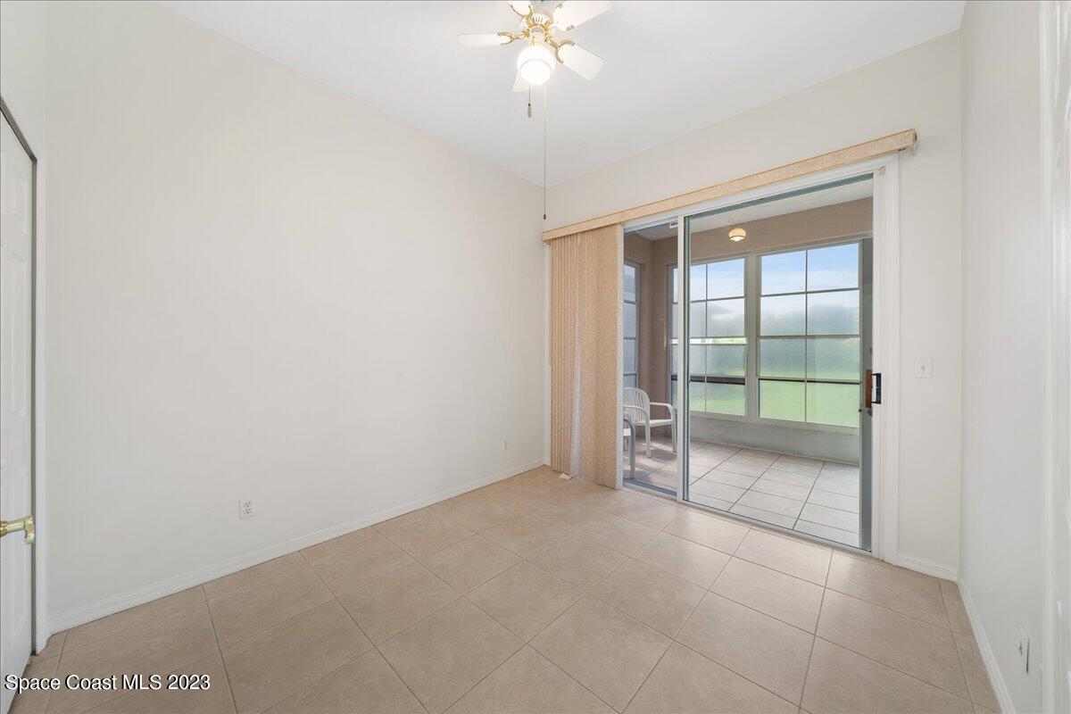 853 Villa Drive Melbourne, FL 32940 - Photo 24 of 28 an empty room with chandelier fan and windows
