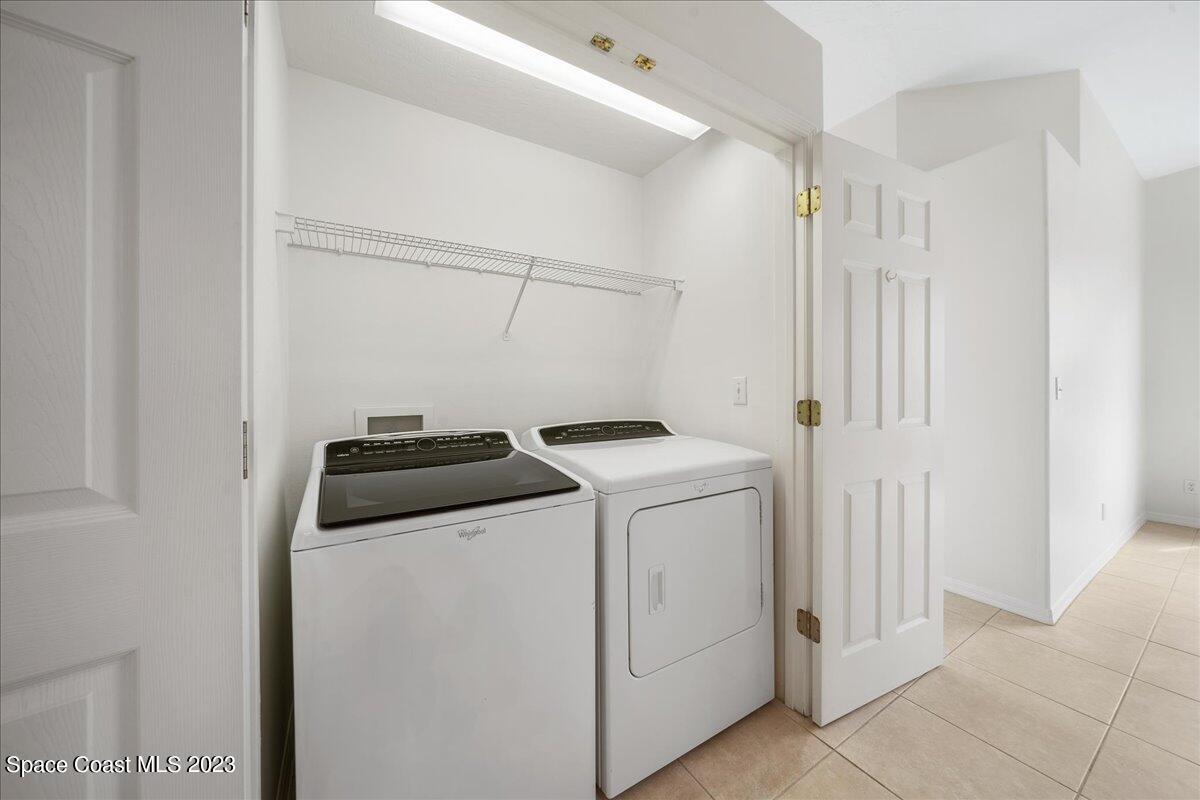853 Villa Drive Melbourne, FL 32940 - Photo 25 of 28 a view of storage and utility room with washer and dryer