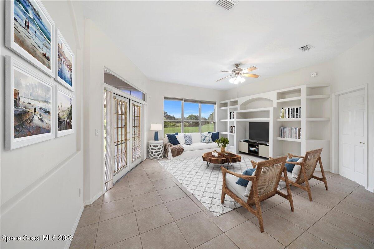 853 Villa Drive Melbourne, FL 32940 - Photo 8 of 28 a living room with furniture a fireplace and a flat screen tv