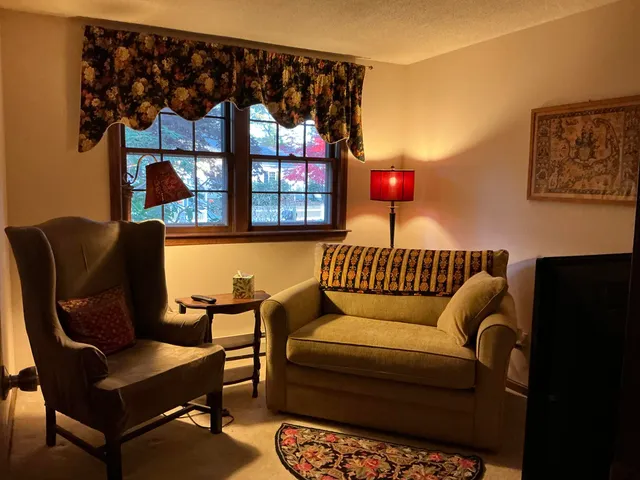 a blue couch sitting in front of a window