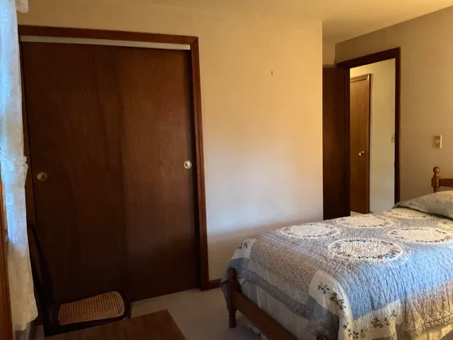 a bedroom with a bed and a mirror
