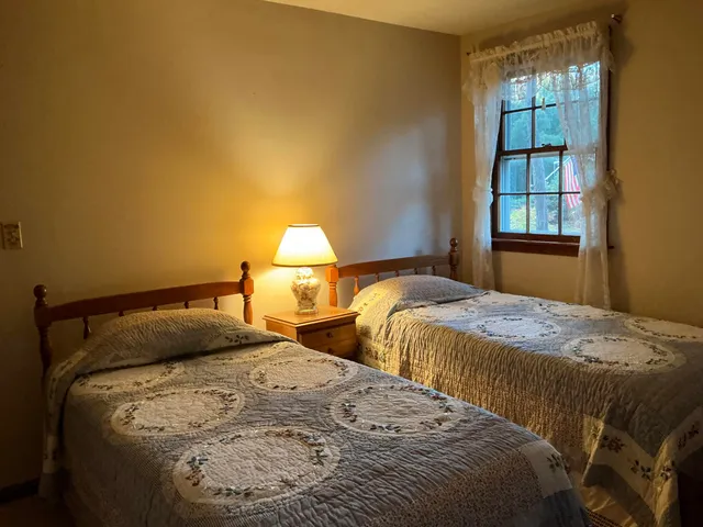 a bedroom with a bed and window