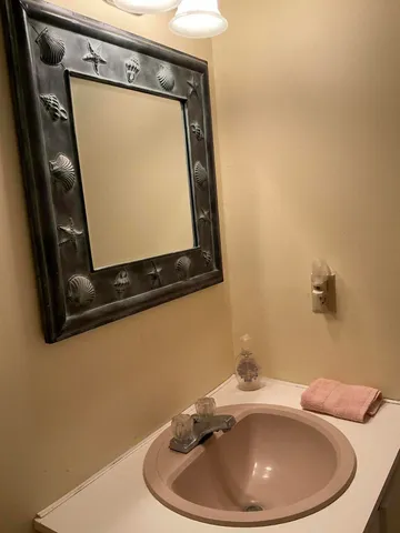 a bathroom with a sink and mirror