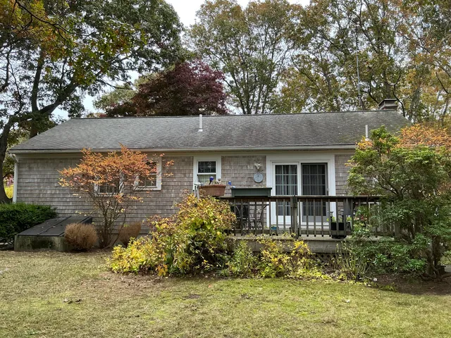 a front view of a house with a yard garage and outdoor seating