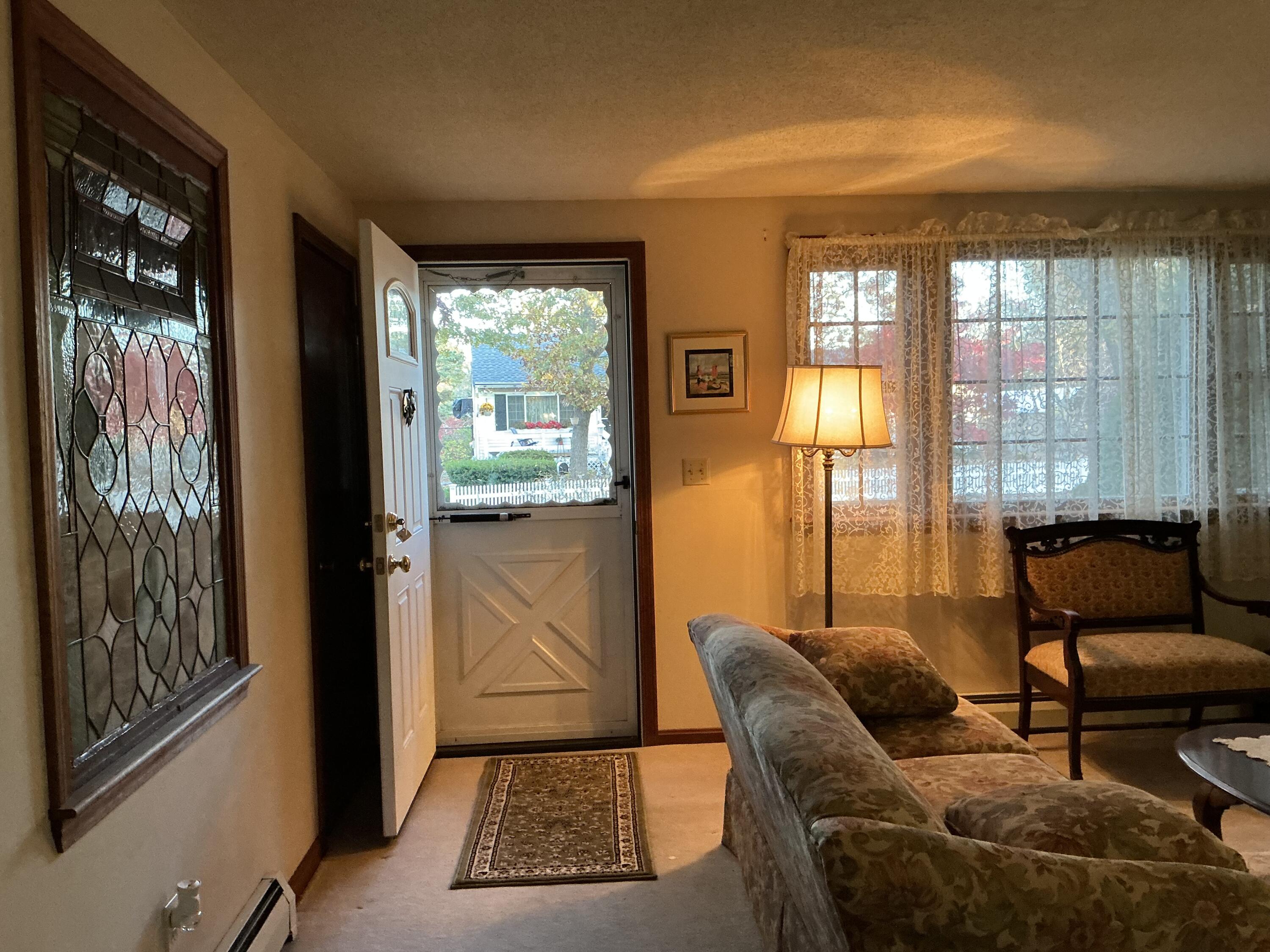 29 Windshore Drive Hyannis, MA 02601 - Photo 31 of 32 a living room with furniture and a floor to ceiling window